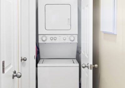 Laundry closet with a stacked washer and dryer