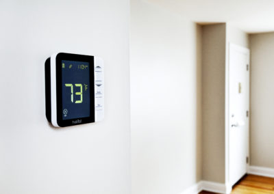 Smart heat and cool monitor on an apartment wall.